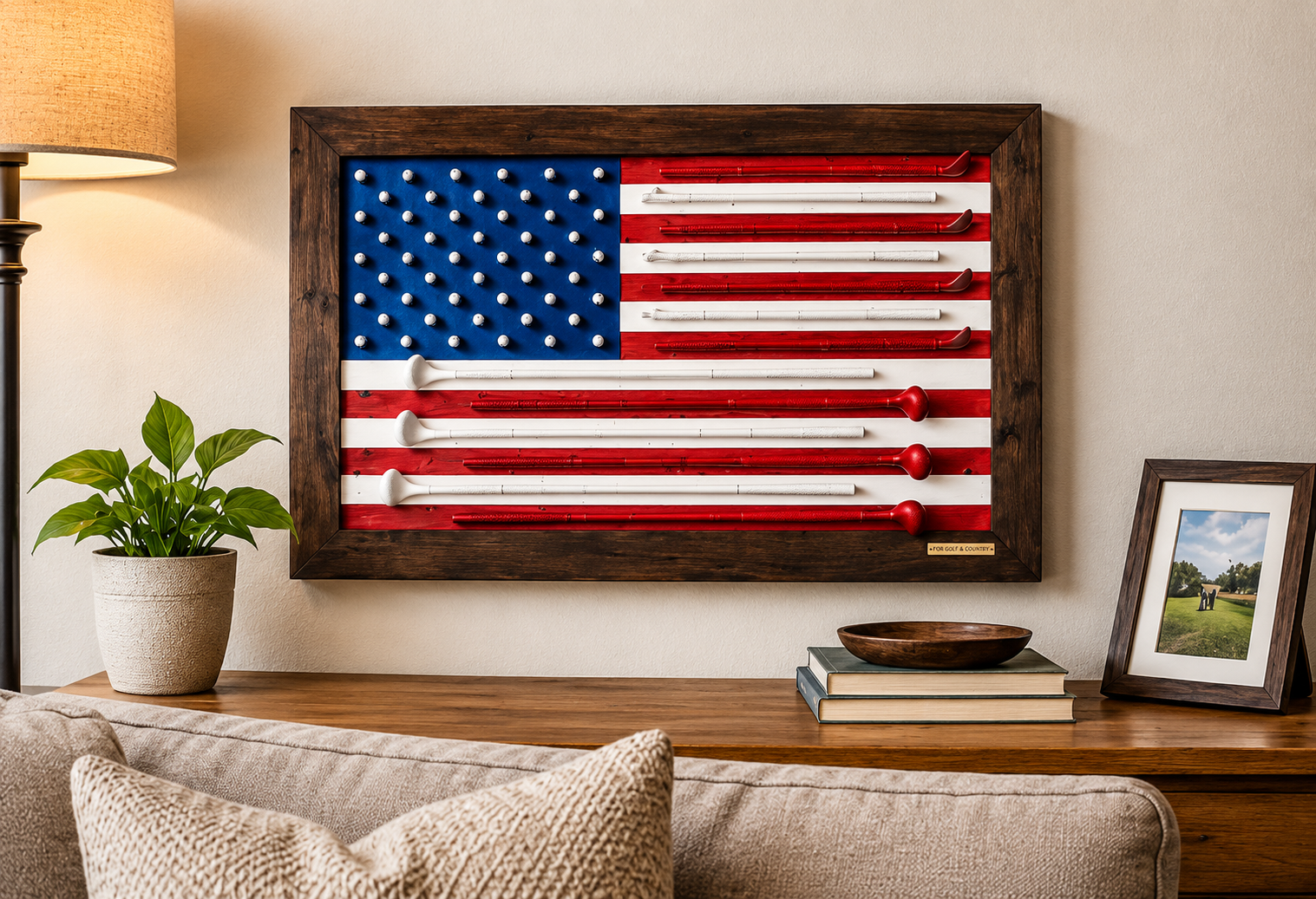 Handcrafted golf club American flag displayed above a wooden console table with books and a framed photograph